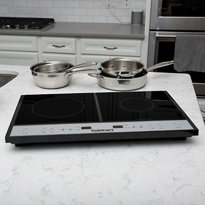 CUISINART <sup>&reg;</sup> Double Induction Cooktop - Two burner induction cooktop heats up faster and uses 70% less energy than conventional cooktops. Left burner has 8 heat settings and right burner offers 5 heat settings.  Sleek glass top design and bright LED timer display. Heat automatically stops 30 seconds after pot or pan is removed from burner.