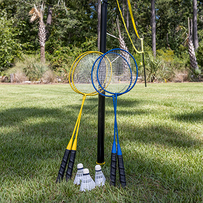 DRIVEWAY GAMES<sup>&reg;</sup> Badminton Set - Includes everything you need to play competitive badminton! The set starts with a deluxe net that's secured by telescoping PVC poles. The poles measure a regulation 5' 1" on each side, while the sleeve-style net measures 20' long by 1.5 ' tall. The net is easy to stabilize because of the double-guide rope system, tension clips, pole anchors, and stakes. The set comes with 3 shuttlecocks and 4 tempered steel rackets with padded grips. 