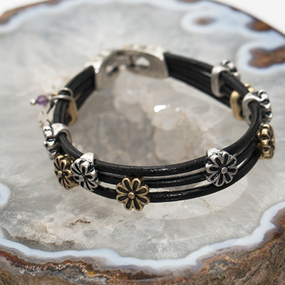 LUCKY BRAND<sup>&reg;</sup> Daisy Leather Bracelet - This bracelet features three rows of leather strands accented with antiqued gold and silver-toned flower charms.  Bracelet has silver-toned closure and measures 7.5"L.