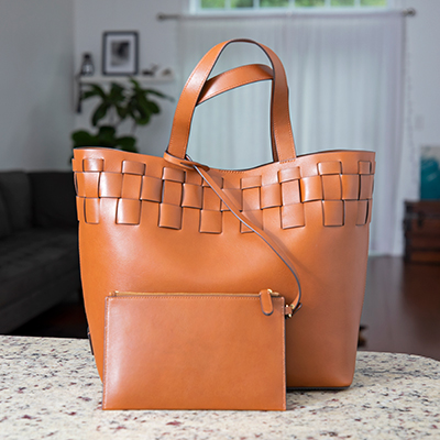 POLO RALPH LAUREN<sup>&reg;</sup> Woven Large Brit Tote Tan - Crafted from smooth, full-grain leather, this large Brit tote bag is elevated by artisanal woven detailing. Designed with a spacious interior equipped with a zip pouch to store your essentials. Features top carry handles and detachable zip pouch.  